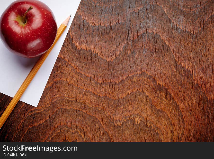 Apple and a pencil on a school notebook