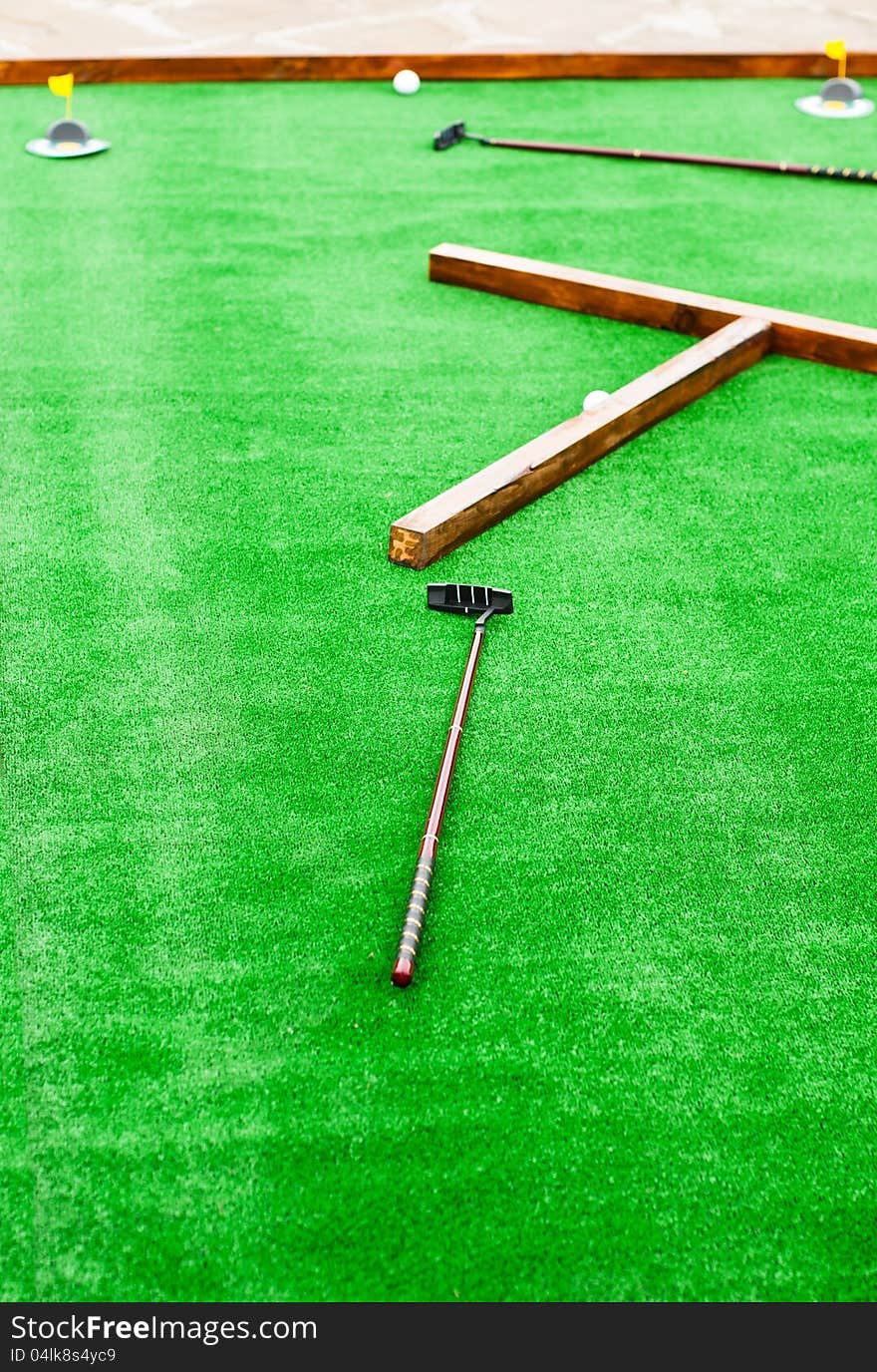 Mini golf field with ball and golf club