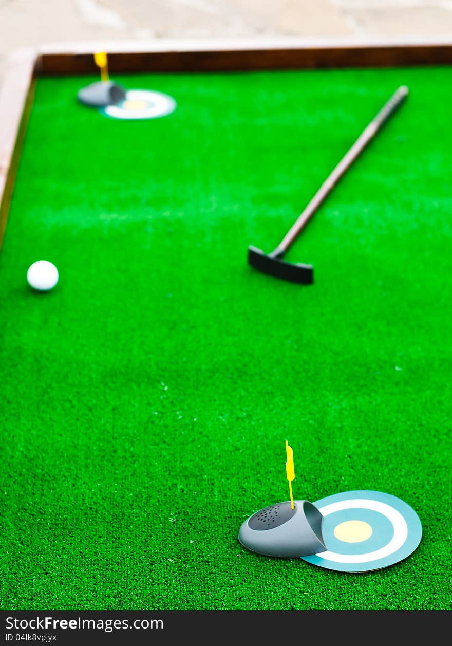 Mini golf field with ball and golf club