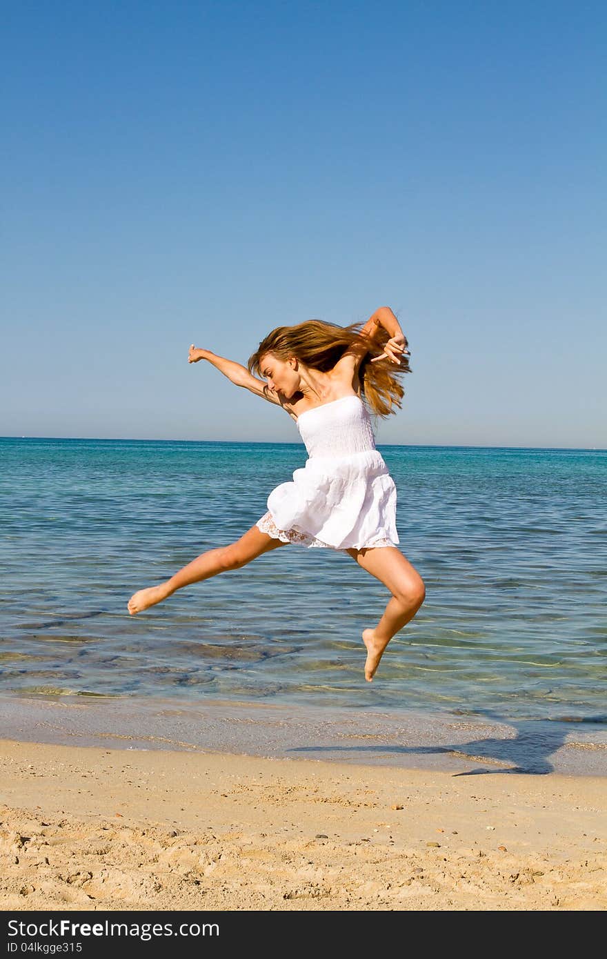 Young  Woman Jumping On The Beach