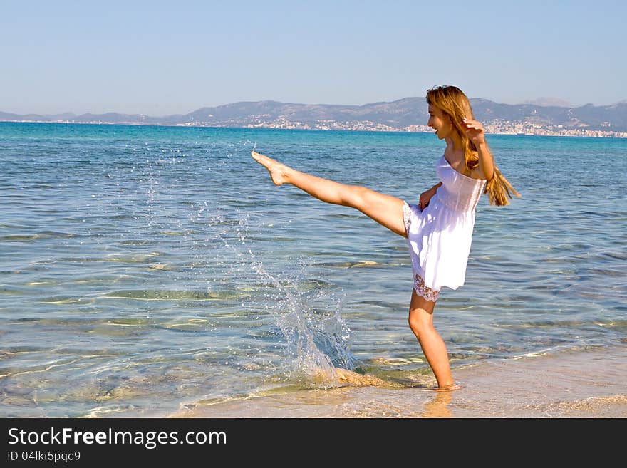 Happy young beautiful woman  on the beach