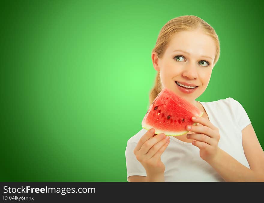 Healthy pretty girl with a slice of watermelon on a green background