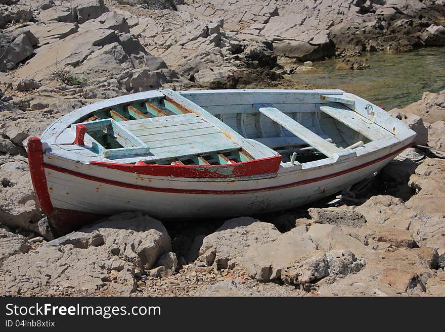 Old wooden boat jobless resting ashore - Adriatic landscape. Old wooden boat jobless resting ashore - Adriatic landscape