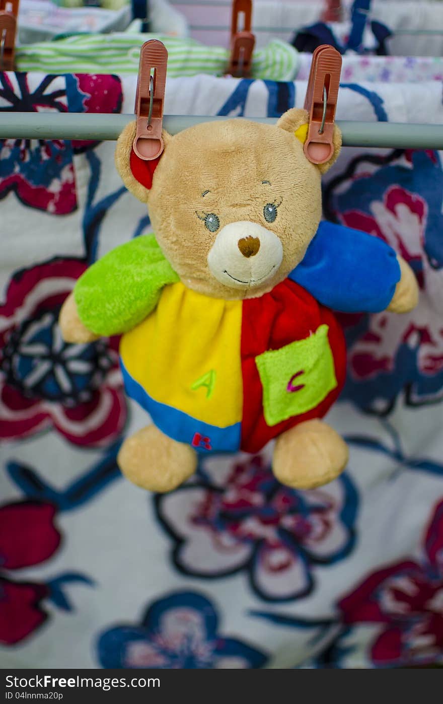 Colorful toys-teddy bear drying with the laundry. Colorful toys-teddy bear drying with the laundry