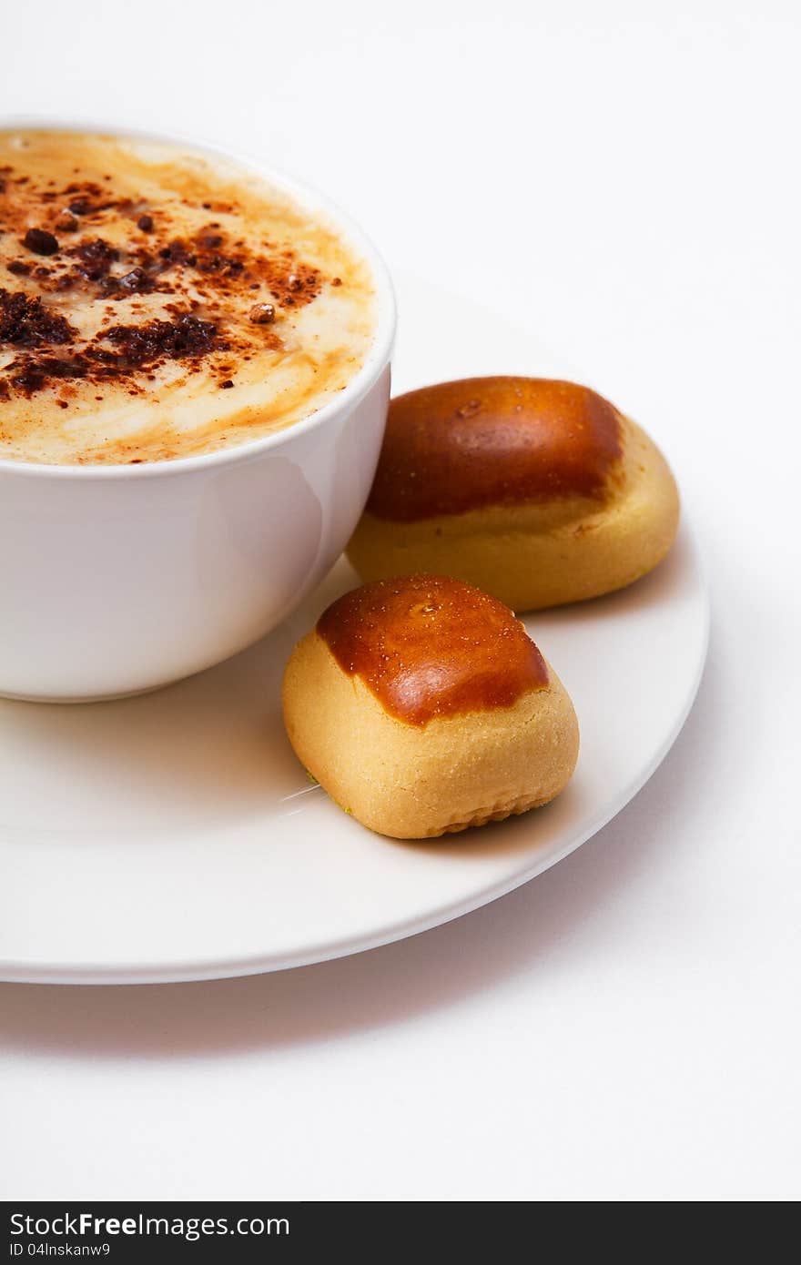 Cup of coffee and sweets on the saucer