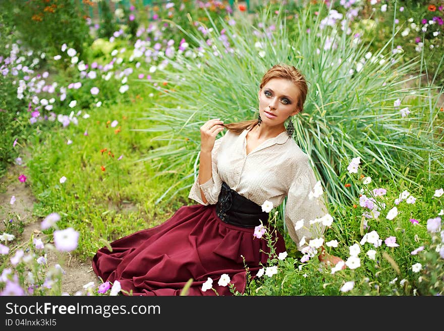 Fashion girl enjoying a summer day in garden