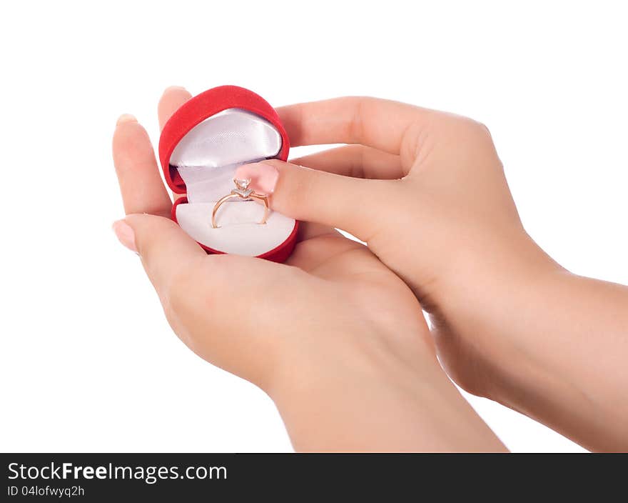 Gold ring in a box in female hands isolated on white background. Gold ring in a box in female hands isolated on white background