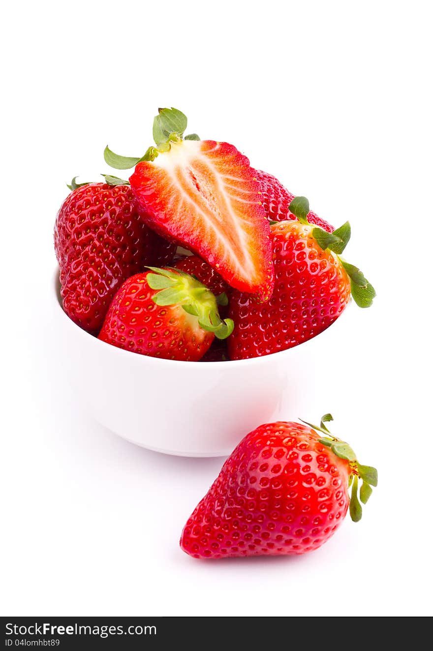 Fresh strawberries in the bowl on the white background