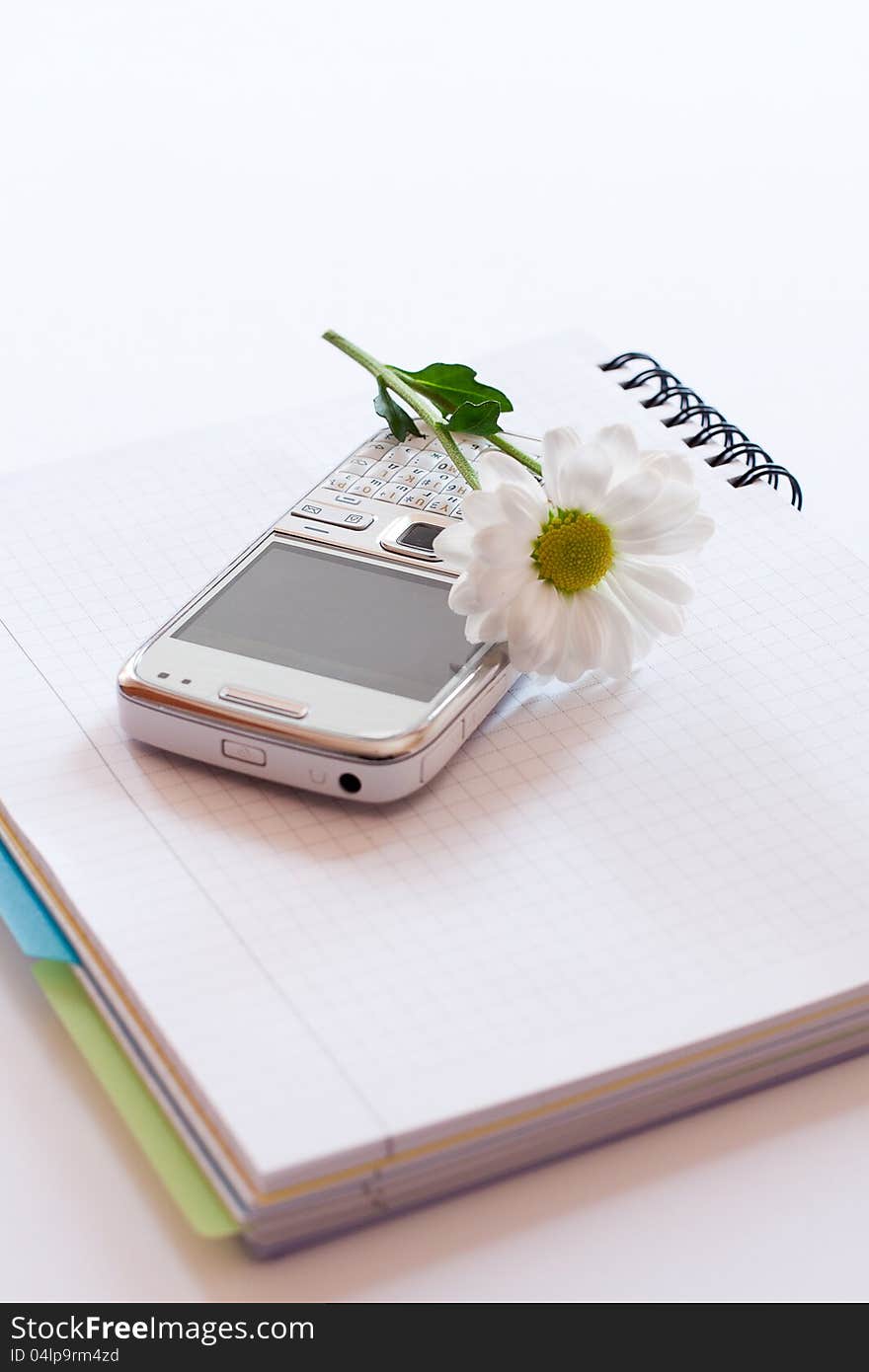 Notebook,mobile phone and flower