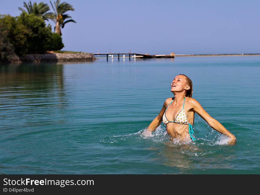 Happy young women playing in the lagoon in El Gouna, Egypt. Happy young women playing in the lagoon in El Gouna, Egypt