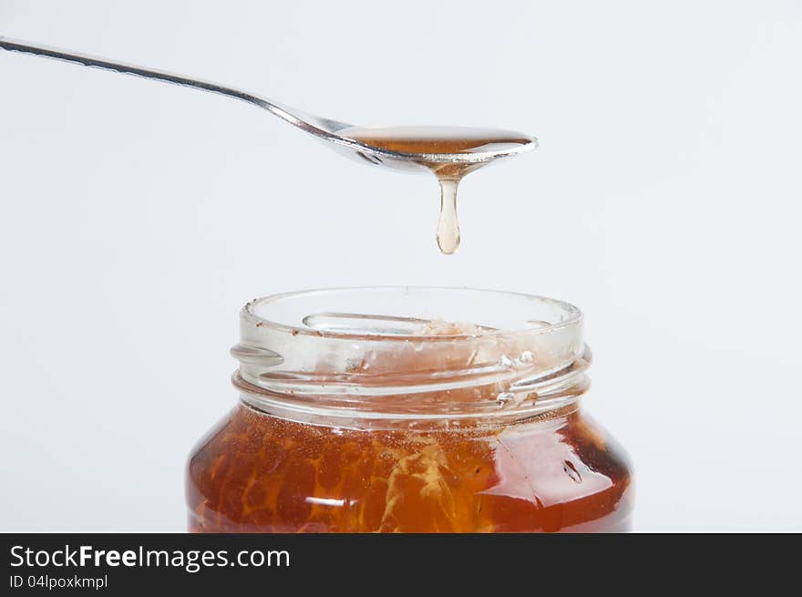 The glass honey jar and white background