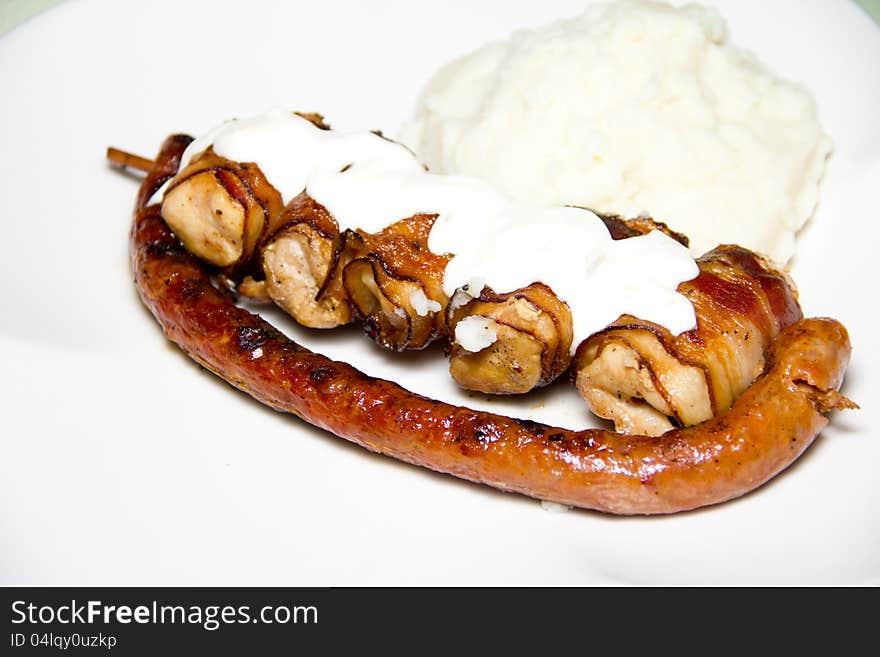 Grilled sausage and chicken with mash