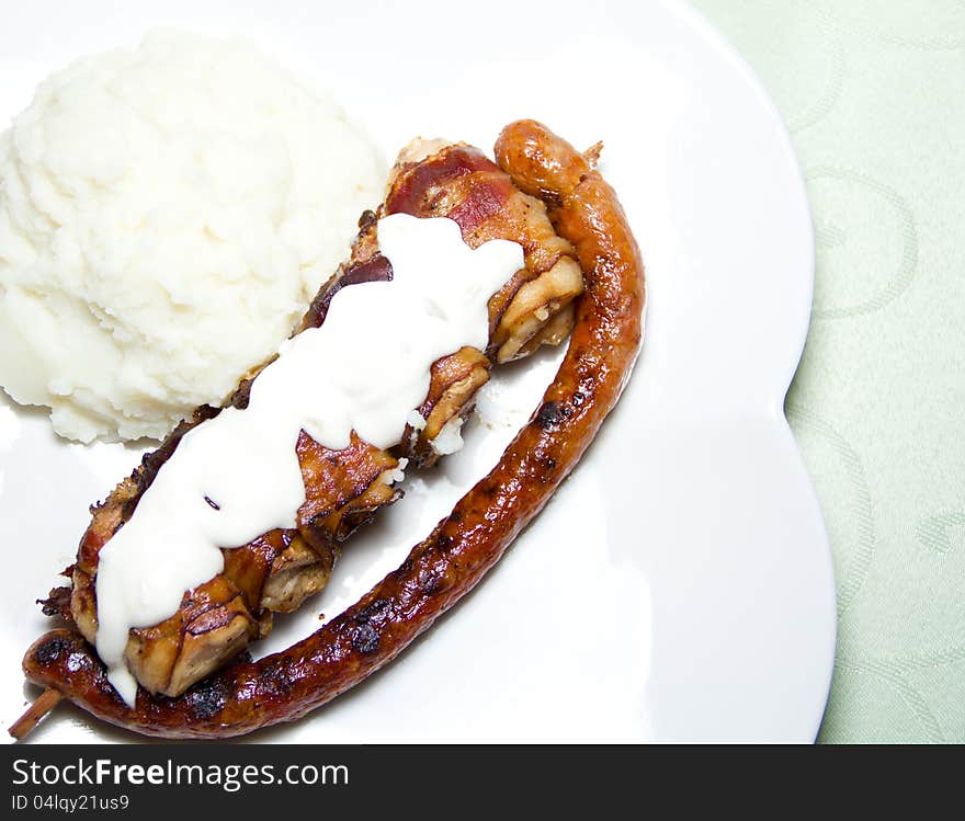 Grilled sausage and chicken with mash