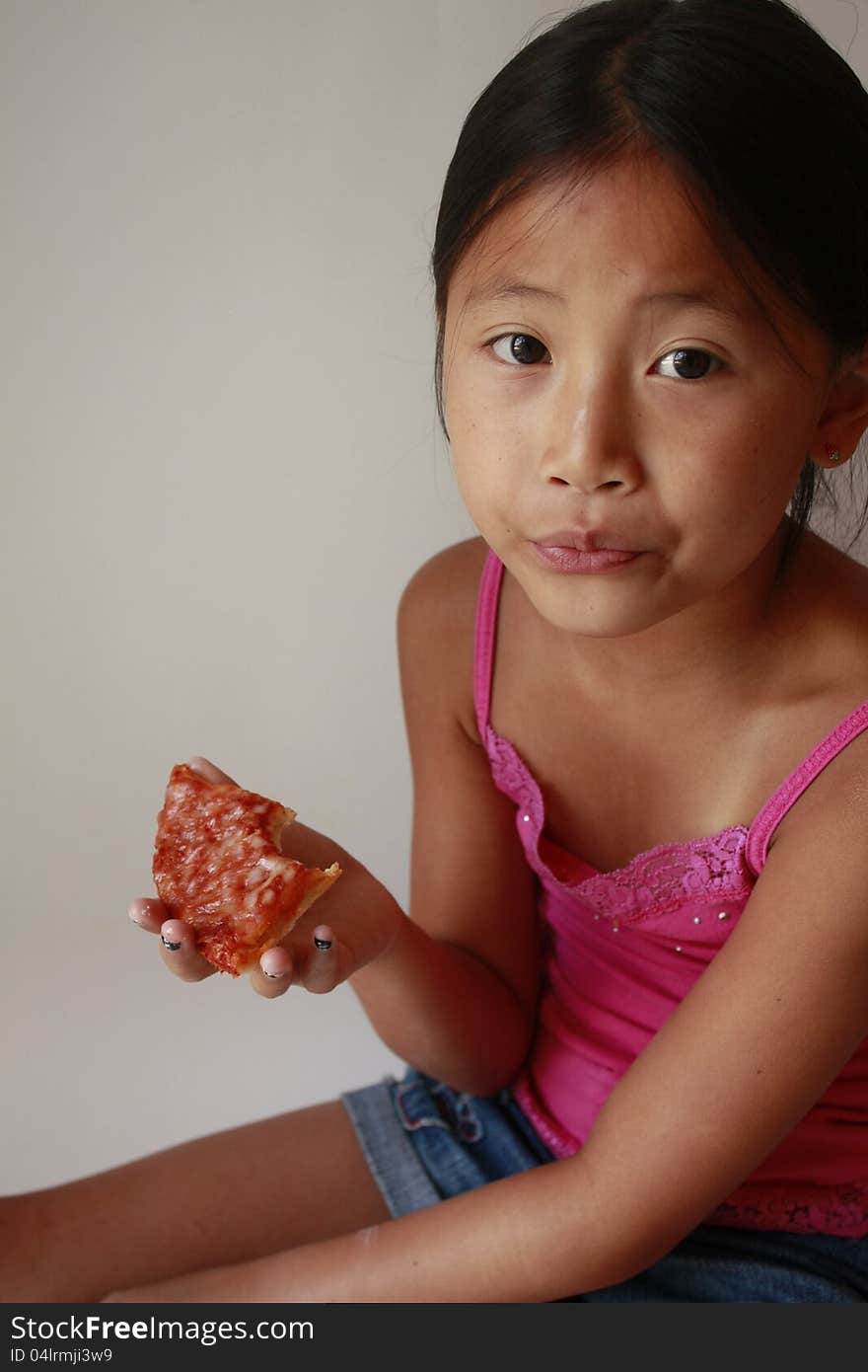 Little Asian Girl Eating Pizza