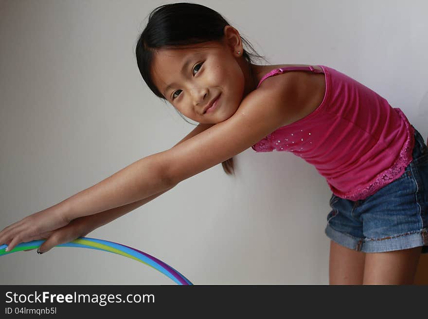 Little Asian Chinese girl holding a hula hoop. Little Asian Chinese girl holding a hula hoop