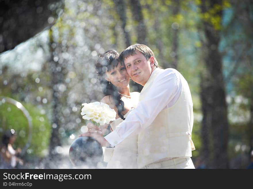 Happy bride and groom with bouquet