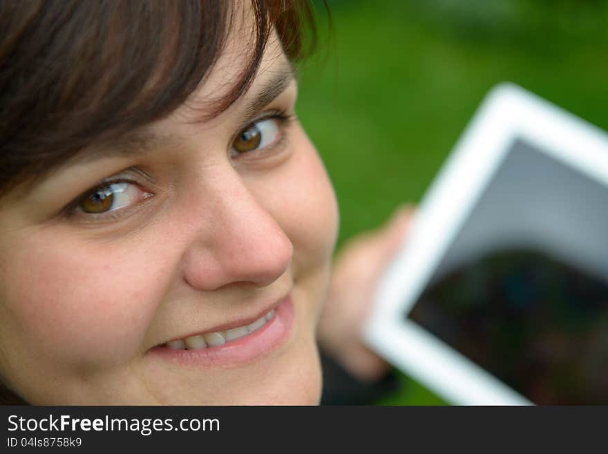 Yougn woman with tablet pc looking up