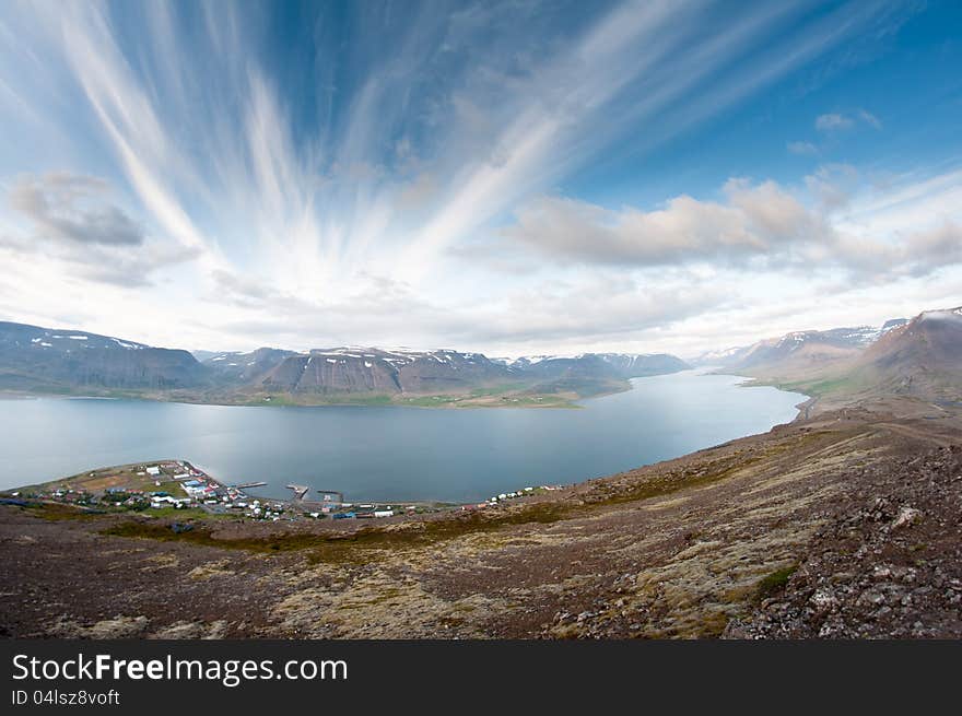 Fjord surrounded by beautiful mountains bathing in evening light. Fjord surrounded by beautiful mountains bathing in evening light