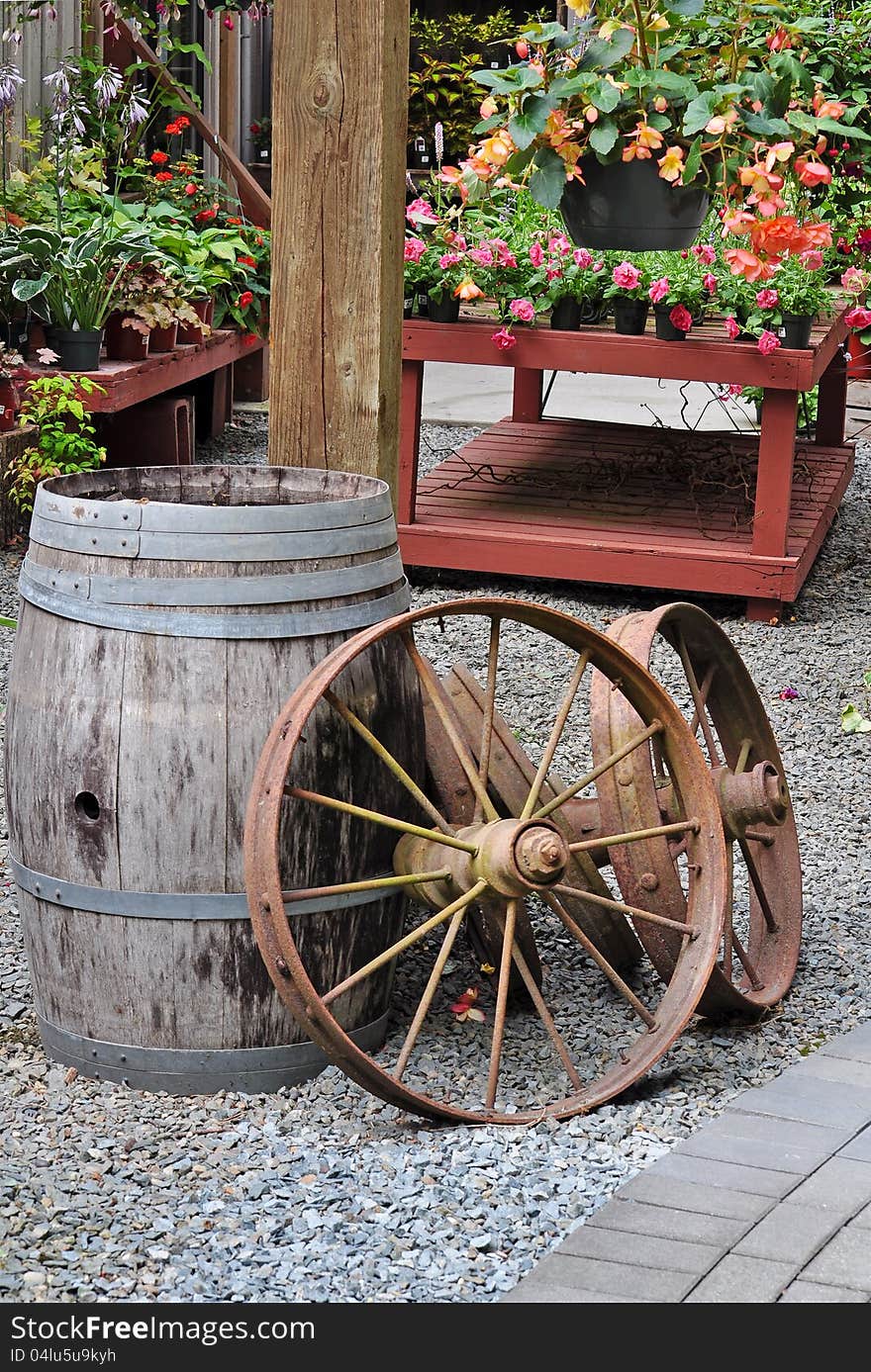 Garden shop with old barrel and wagon wheels on display