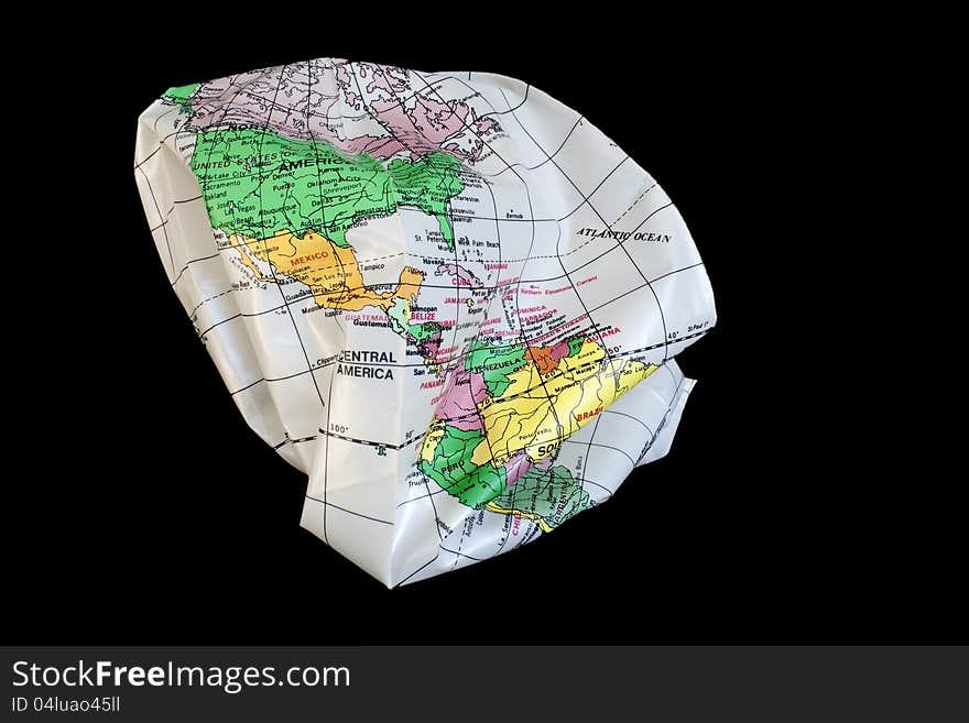 Earth globus colapsing in itself, isolated in black background. Earth globus colapsing in itself, isolated in black background.