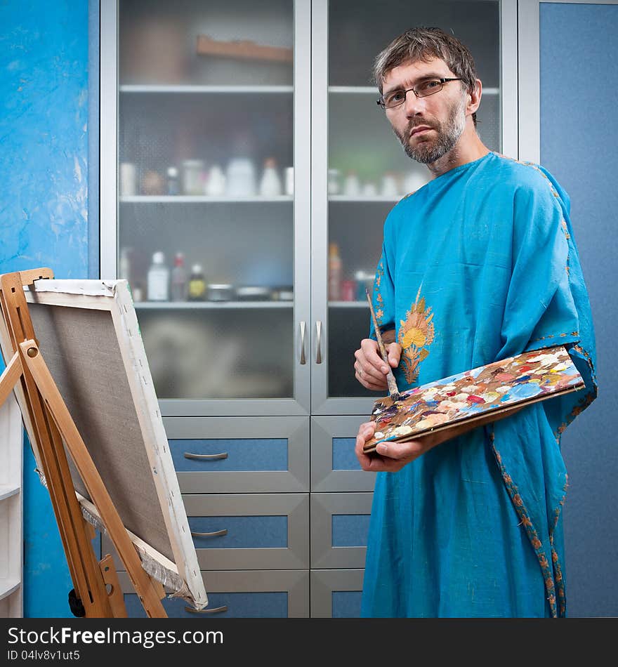 Artist paints picture in the studio