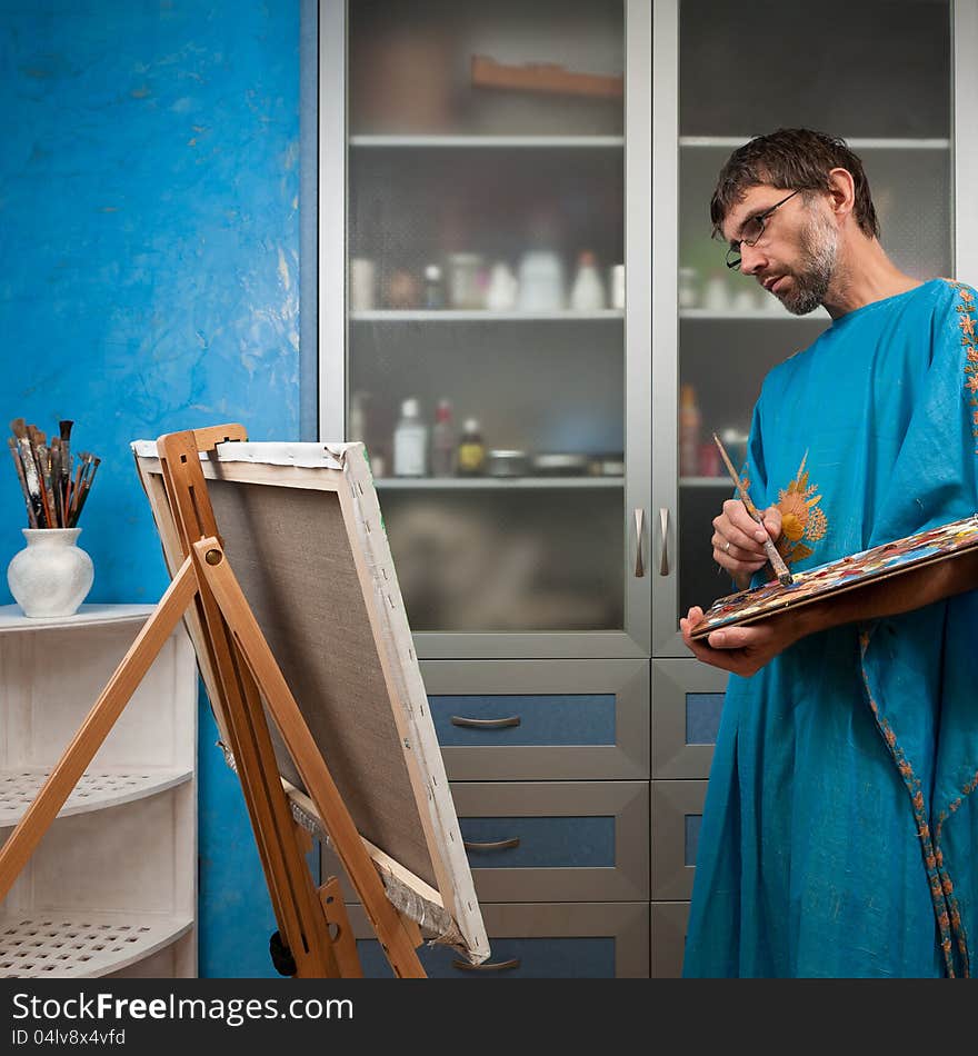 Artist paints picture in the studio