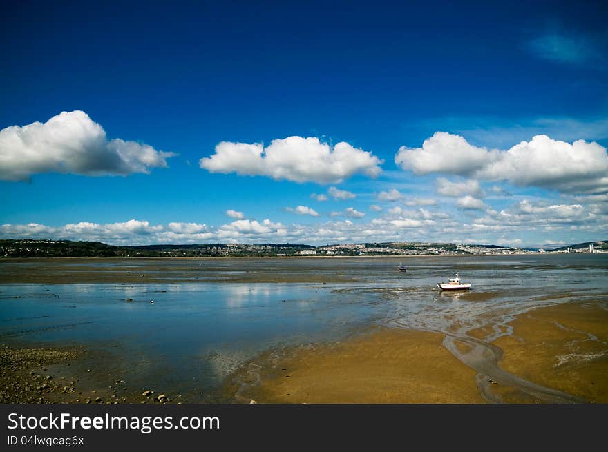 Welsh coast lone boat cloudscape