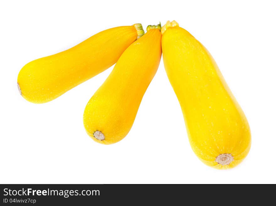 Three golden yellow zucchini isolated on white