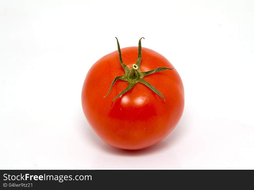 Single fresh red tomato isolated on white