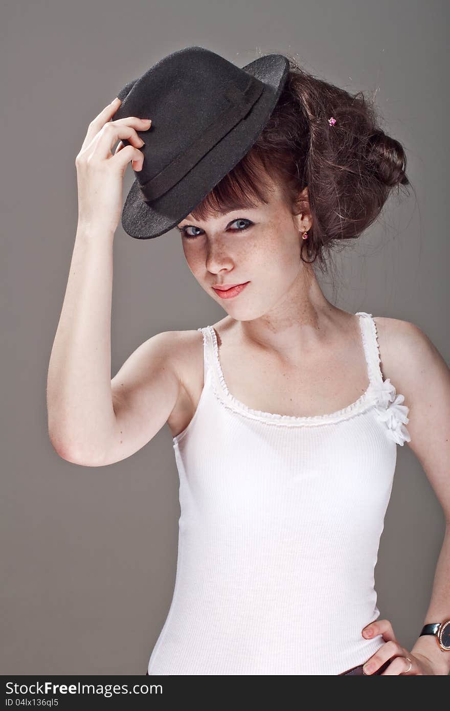 Portrait of a beautiful shy girl with freckles and black hat. Portrait of a beautiful shy girl with freckles and black hat