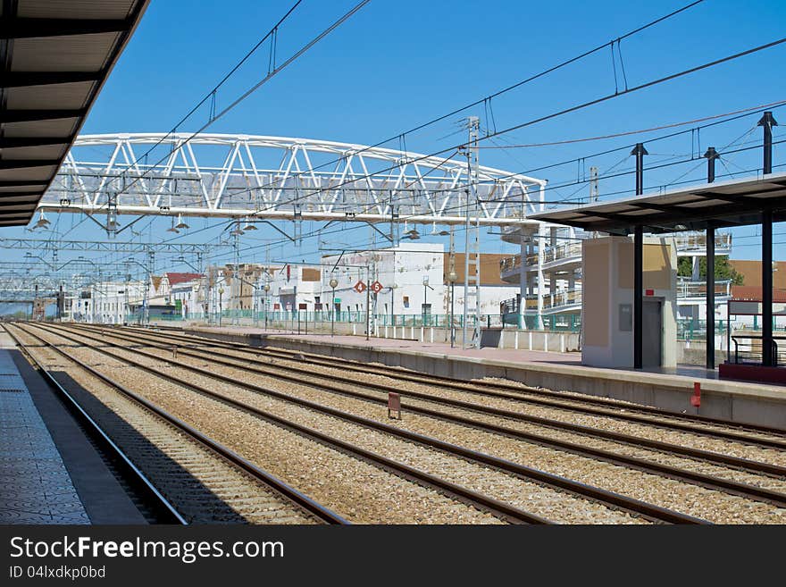 A train station with no train. View of many rails and electrificated aerial lines. Photo taken in Spain.