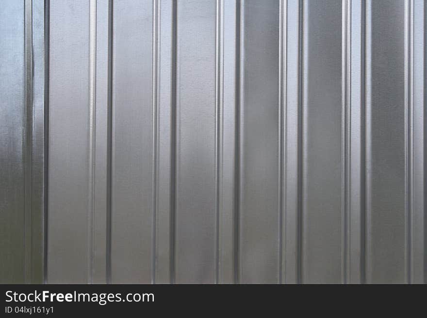 Photo of gray corrugated metal texture with horizontal strips.