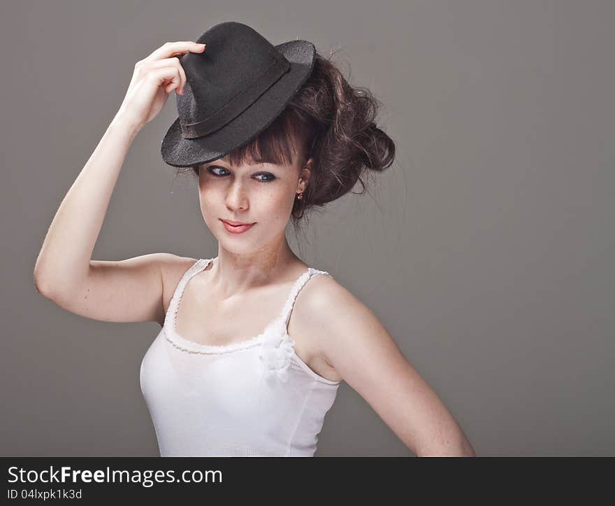 Portrait of a beautiful shy girl with freckles and black hat. Portrait of a beautiful shy girl with freckles and black hat