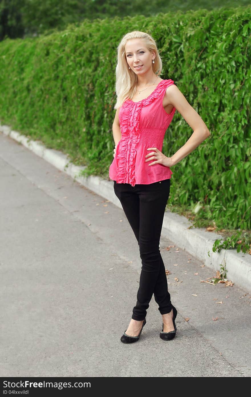 Portrait of young pretty blond woman outdoors