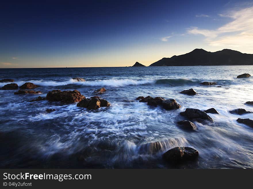 Rocks in wave at sun set moment