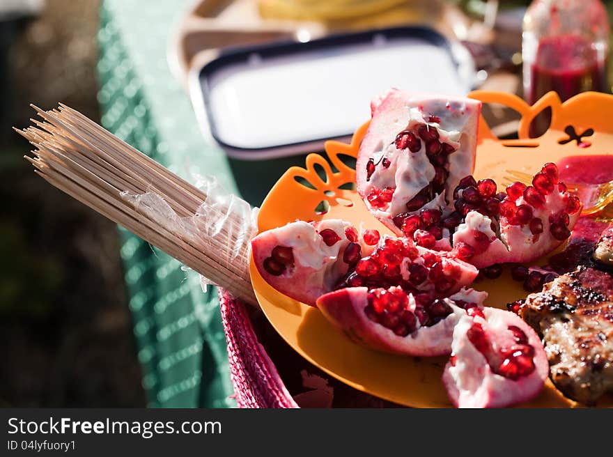 Barbecue grill with pomegranate on table. Barbecue grill with pomegranate on table