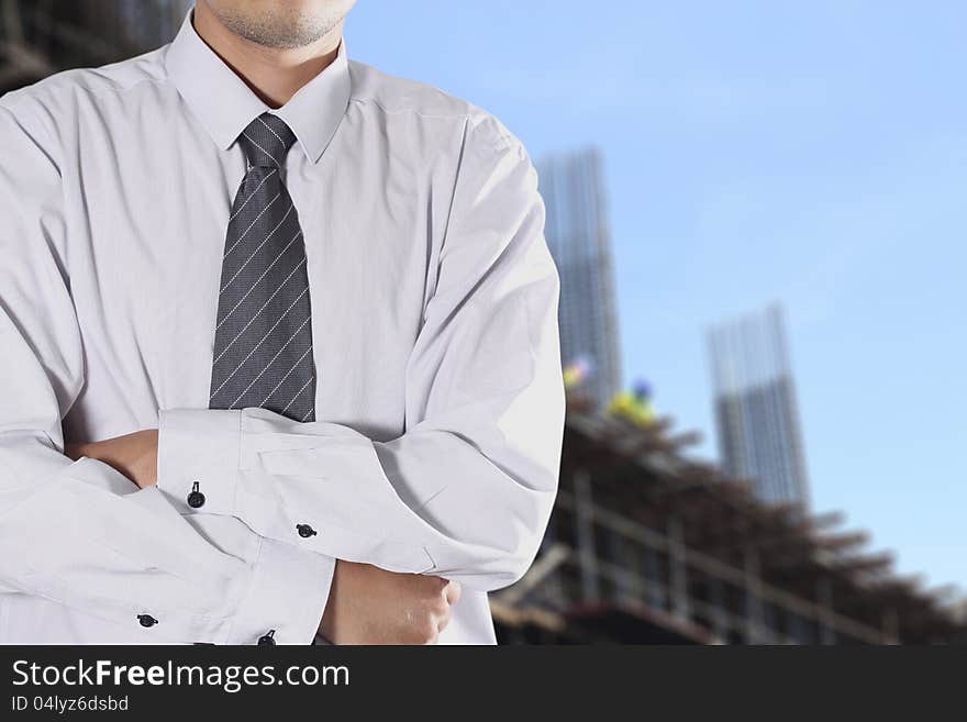 Cropped view of Businessman standing in front the construction