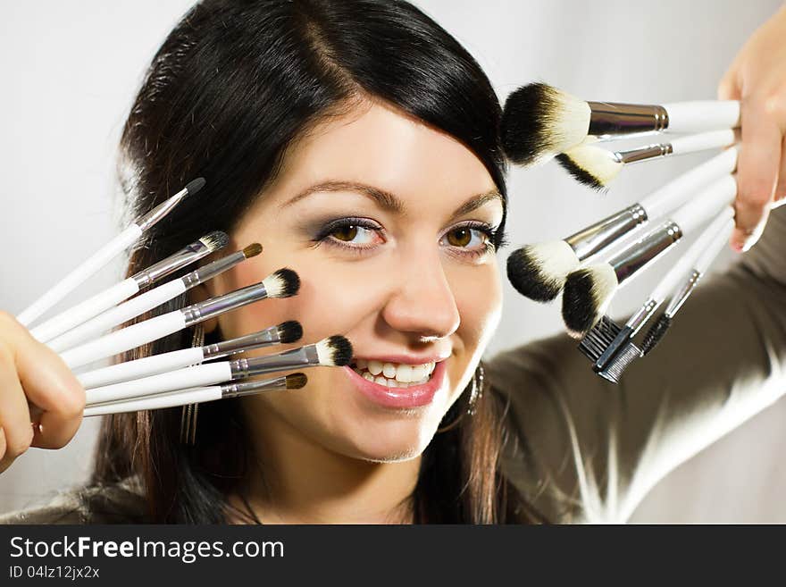 Beautiful Woman With Makeup Brushes