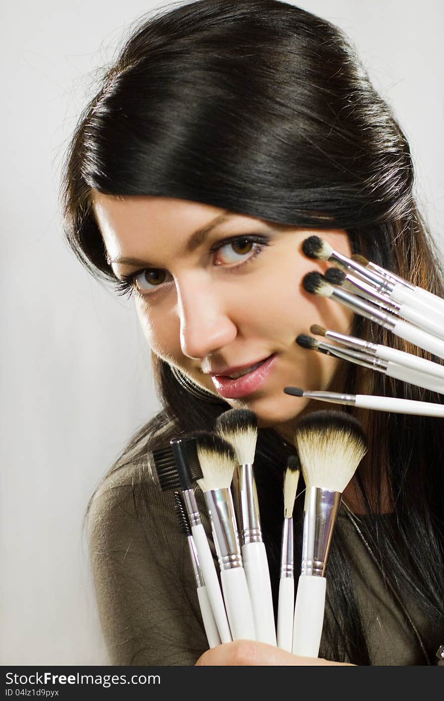 Beautiful Woman With Makeup Brushes