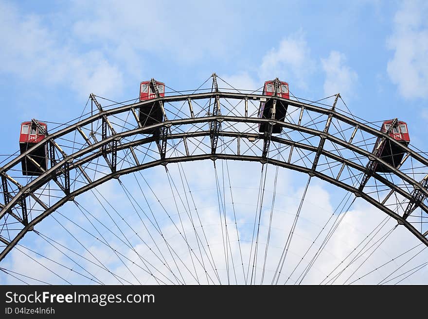 Closeup of famous Ferris wheel against blue sky with clouds in Prater Park, Vienna, Austria