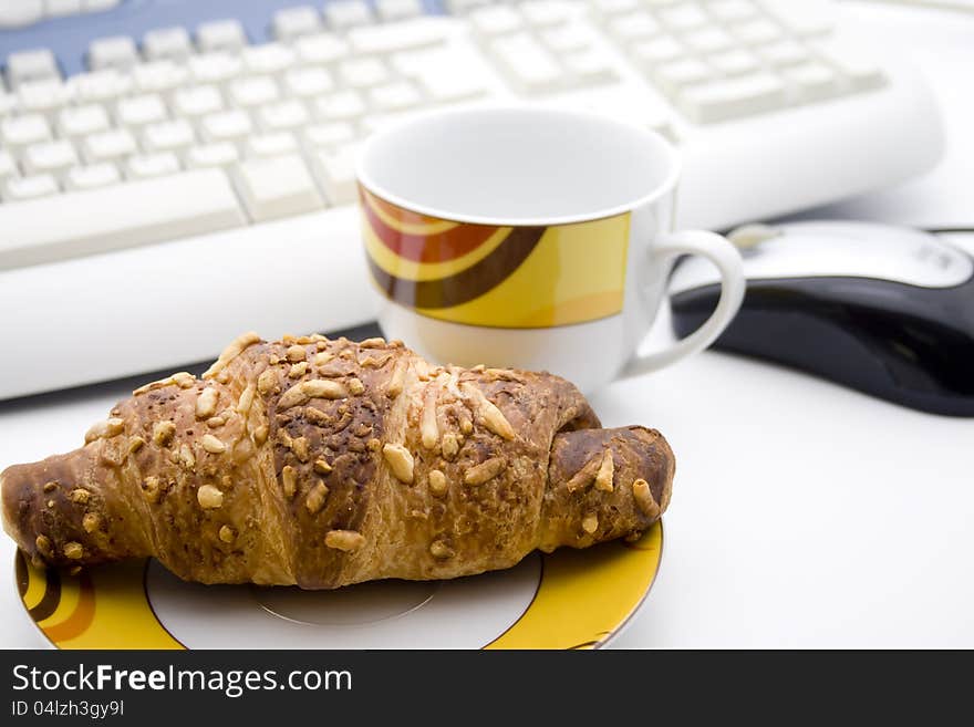 Cake on plate and cup with keyboard