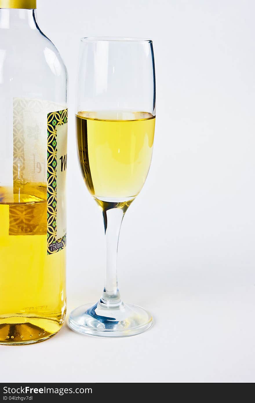 Bottle with a glass of white wine were photographed on a white background