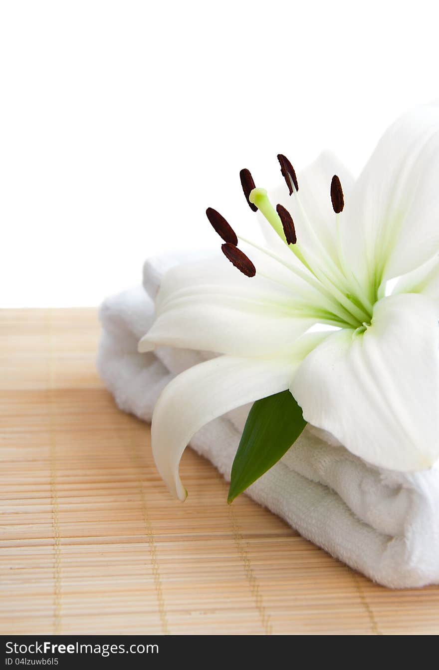 White lily and  towel  on a white background. White lily and  towel  on a white background