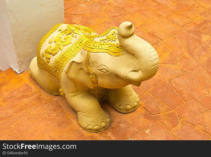 Stone elephant statue on outdoor clay tiles