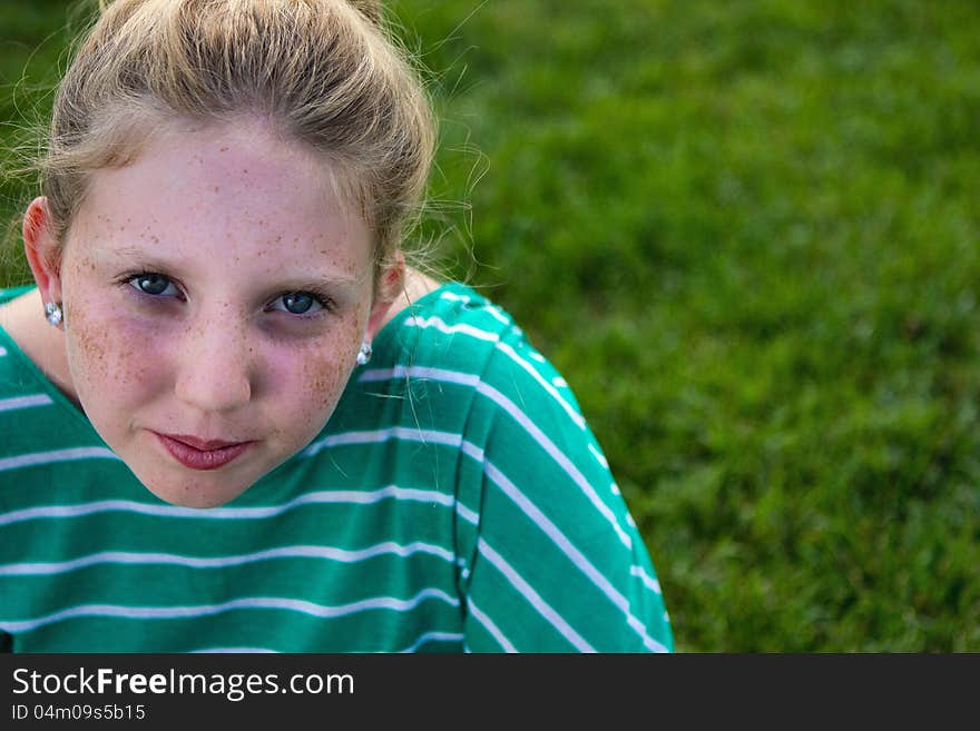 Adolescent on a green field