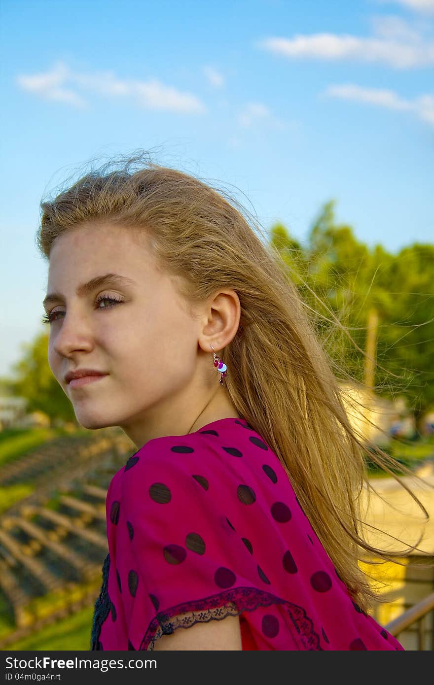 Preteen female outdoors on a sunny, breezy day