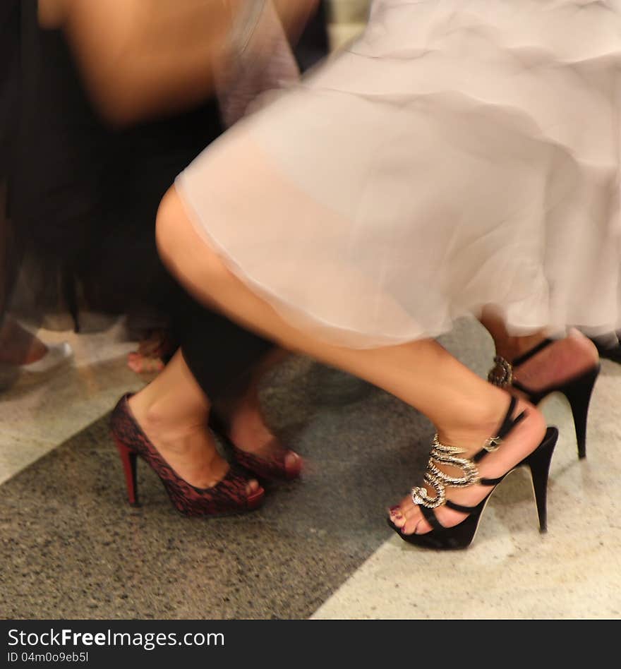 Women in high heeled shoes dancing at a party. Women in high heeled shoes dancing at a party