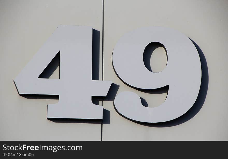 The large numerals have been sculpted in grey metal and stand out clearly on the grey background. The large numerals have been sculpted in grey metal and stand out clearly on the grey background.