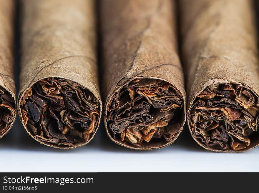 Four cigars laying on the table.