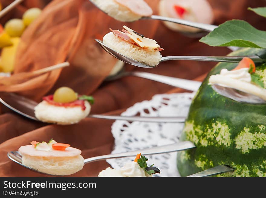 A spoon of circled breads with filling. A spoon of circled breads with filling.